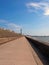 Vertical perspective view along the pedestrian promenade in blackpool with a view of the town north pier and tower