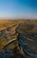 Vertical photo. Aerial view point of Love Valley Peri Bacalari Sunset over Red valley in Cappadocia canyon, mountains and balloons