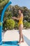 Vertical photo of an asian girl in a shower at a pool