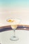 Vertical photo of Banana Daiquiri drink with passion fruit on the glass table ocean background at the beach