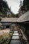 Vertical photo of a beautiful wooden cabin deep in the forest - Mlyny Oblazy Slovakia. Old wooden mill with rocks on background