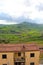Vertical photo capturing amazing Sicilian landscape with houses in village Gangi in Italy. Cloudy day. Green hilly countryside.