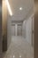 Vertical photo of corridor in beige stylish Interior design of the apartment. Design in beige tones. Doors in the color of the