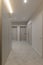 Vertical photo of corridor in beige stylish Interior design of the apartment. Design in beige tones. Doors in the color of the