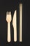 Vertical photo. Disposable tableware made of natural materials, knife, wooden fork