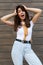 Vertical photo of emotional positive happy joyful pretty young brunette woman in trendy outfit. Beautiful attractive