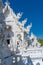 Vertical photo of the entrance of the white temple of Chiang rai in Thailand