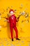 Vertical photo of freak guy hold money gun shoot dollars wear cock polygonal mask red suit isolated yellow color