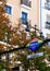 Vertical photo of gay symbolic in lgbt friendly district in Madrid, Spain. Chueca metro station signboard with autumnal background