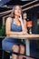 Vertical photo of a girl in a cafe. A girl in a blue top sits sideways