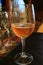 Vertical photo of a glass of amber color chilled craft beer on the dining table