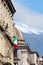 Vertical photo of historical building in Sicilian Catania, Italy with waving Italian flag on the facade. In background cupola of