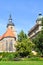 Vertical photo of historical Franciscan Monastery and Church in Plzen, Czech Republic taken with green park in Krizikovy sady.