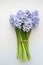 Vertical Photo Of Little Bouquet Of Blue Spring Flowers Hyacinths On A White Background