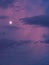 Vertical photo moon lit with blue and pink clouds