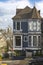 Vertical photo Painted Ladies of San Francisco in the state of California, USA. Californian Victorian houses of USA with vehicles