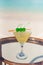 Vertical photo of Pina Daiquiri drink on the glass table ocean background at the beach