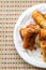 Vertical photo plate spring roll asia snack fried delicious tasty crisp tasty part close up