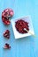 Vertical photo of pomegranate fruits inside a white bowl