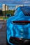 Vertical photo of Porsche 911 Carrera 4S & x28;Miami Blue& x29; 992 Sports with space for text rear view of trunk and headlights