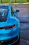 Vertical photo of Porsche 911 Carrera 4S & x28;Miami Blue& x29; 992 Sports with space for text rear view of trunk and headlights