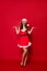 Vertical photo of pretty lady enjoy snowfall at xmas eve wear fluffy snow dress isolated red background