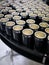 Vertical photo of a raw of beer cans on a platform of a brewery packaging plant