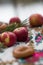 Vertical photo red apples on a light blurred background, outdoors on a beautiful tablecloth