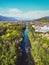 Vertical photo of a river running trough the suburbs on a sunny spring day