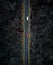 Vertical photo of the road with two cars with motion blur from above by drone - night time photo in Lanzarote. Straight road among