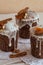 Vertical photo of three stylish traditional Orthodox Easter delicious cakes on the white napkins decorated by dried bananas,