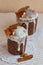 Vertical photo of two stylish traditional Orthodox Easter delicious cakes on the white napkins decorated by dried bananas, orange