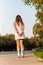 Vertical photo of a woman wearing a dress skating with inline skate