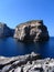 Vertical picture of the Fungus Rock surrounded by the sea under the sunlight in Gozo in Malta