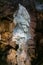 Vertical picture of a giant white stalagmite inside Postojna cave.