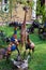 Vertical picture of handcrafted sculptures of three giraffes on a green garden of Cultural Heritage store in Arusha, Tanzania