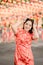 Vertical picture. Happy Chinese new year. Asian woman wearing traditional cheongsam qipao dress posing rabbit in Chinese Buddhist