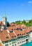 Vertical picture of Nydegg Church and historical buildings located along turquoise Aare River in Bern, Switzerland. Religious