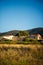 Vertical picture of old traditional stone provencale farmyard in Provence, France with Luberon hill on background in hot summer