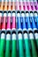 Vertical picture soft focus close-up of palette of colored markers in box with plastic insert. Colored drawing markers in a
