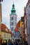Vertical picture of the tower of St. Jost Church between colorful houses, in Cesky Krumlov, Czech Republic