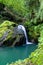 Vertical picture of a waterfall surrounded by greenery in the Devil`s Pass park in Skrad, Croatia