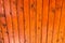 Vertical pine wood boards painted in orange color