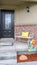 Vertical Porch with bench of a home with glass paned door and concrete and brick wall