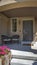 Vertical Porch chairs by the gray wooden front door and window of a home