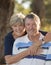 Vertical portrait of American senior beautiful and happy mature couple around 70 years old showing love and affection smiling toge