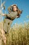 Vertical portrait of beautiful young woman in the field. girl in ears of wheat on summer field outdoors, fashion and model