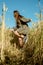 Vertical portrait of beautiful young woman in the field. girl in ears of wheat on summer field outdoors, fashion and model