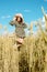 Vertical portrait of beautiful young woman in the field. girl in ears of wheat on summer field outdoors, fashion and model