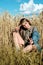 Vertical portrait of beautiful young woman in the field. girl in ears of wheat on summer field outdoors, fashion and model